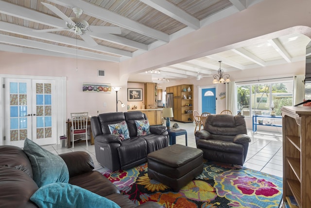 living room with light tile patterned flooring, ceiling fan with notable chandelier, beam ceiling, and french doors