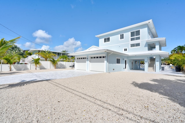 view of front of property with a carport and a garage