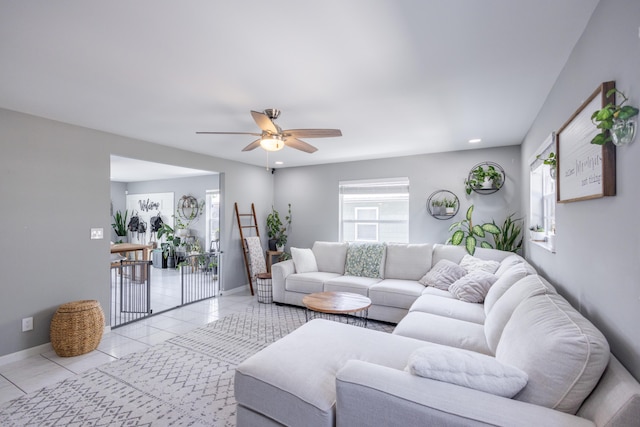 living room with ceiling fan and light tile patterned floors