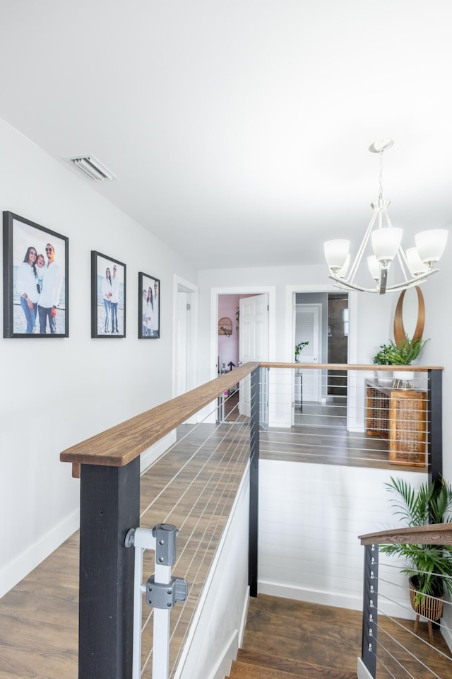 kitchen featuring a breakfast bar area, butcher block counters, hanging light fixtures, dark hardwood / wood-style floors, and a chandelier