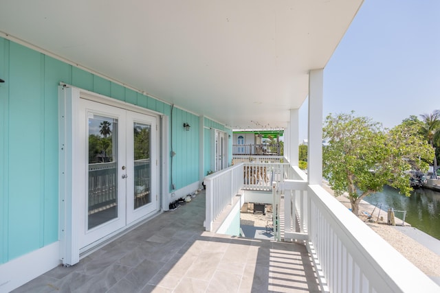 balcony with french doors and a water view