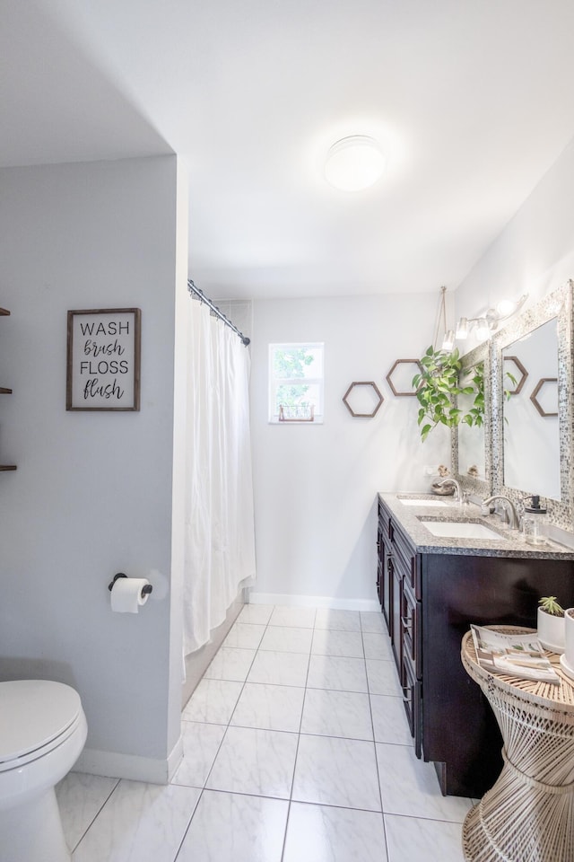 bathroom featuring vanity, toilet, and a shower with shower curtain