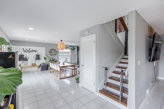 staircase featuring tile patterned flooring