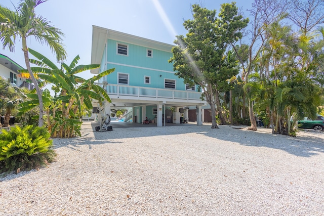 rear view of house featuring a carport