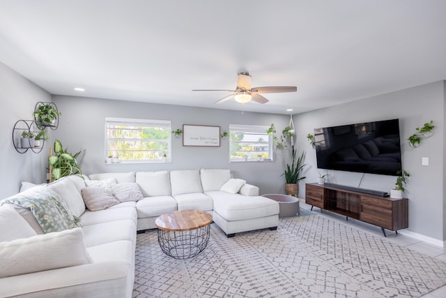 living room featuring plenty of natural light and ceiling fan