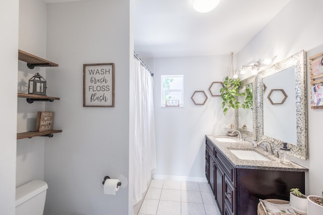 bathroom with a shower with curtain, vanity, tile patterned floors, and toilet