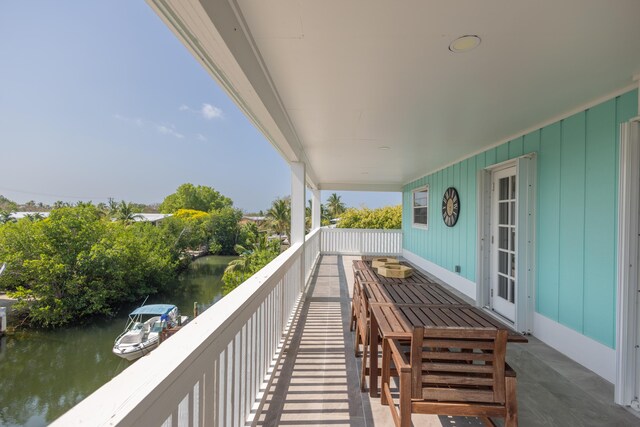 balcony featuring a water view