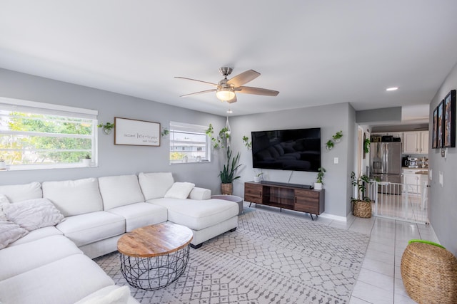 tiled living room with ceiling fan and a healthy amount of sunlight