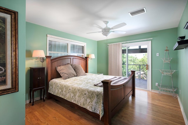 bedroom featuring baseboards, visible vents, ceiling fan, wood finished floors, and access to outside