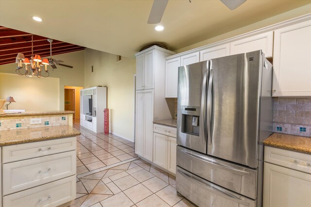 kitchen featuring light tile patterned floors, ceiling fan with notable chandelier, stainless steel refrigerator with ice dispenser, and backsplash