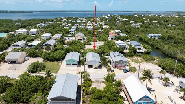 drone / aerial view with a water view and a residential view