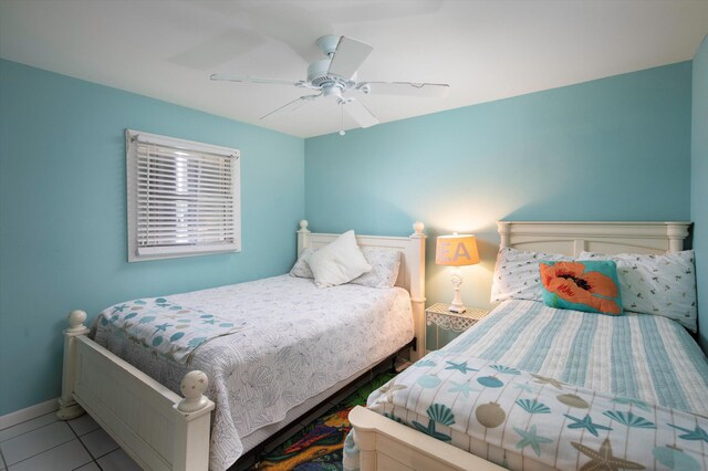 bedroom with baseboards, a ceiling fan, and tile patterned floors