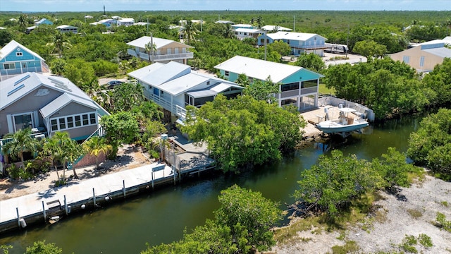 birds eye view of property with a residential view and a water view