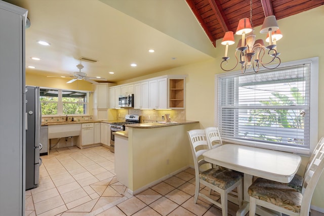 kitchen with stainless steel appliances, a peninsula, visible vents, decorative backsplash, and open shelves