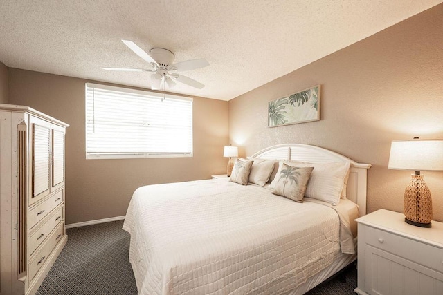 bedroom with baseboards, a textured ceiling, a ceiling fan, and dark colored carpet