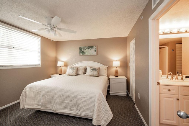 bedroom featuring dark colored carpet and a textured ceiling