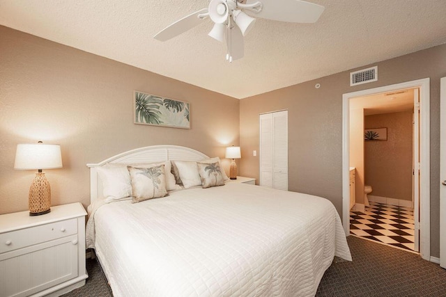 bedroom with a closet, visible vents, a textured ceiling, and a ceiling fan