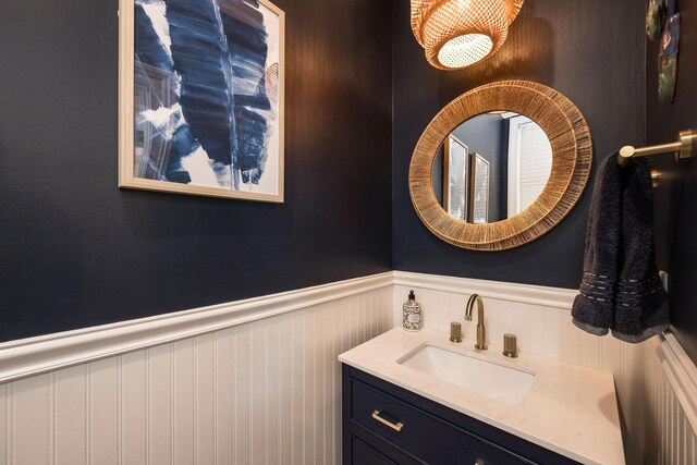 106 Admirals Ln, Key West, FL 33040 - bathroom with wainscoting, vanity, and a decorative wall