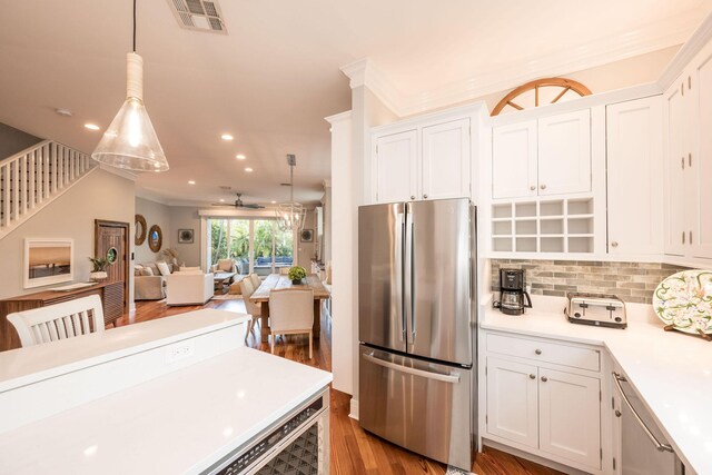 106 Admirals Ln, Key West, FL 33040 - kitchen with freestanding refrigerator, light countertops, white cabinets, wood finished floors, and recessed lighting