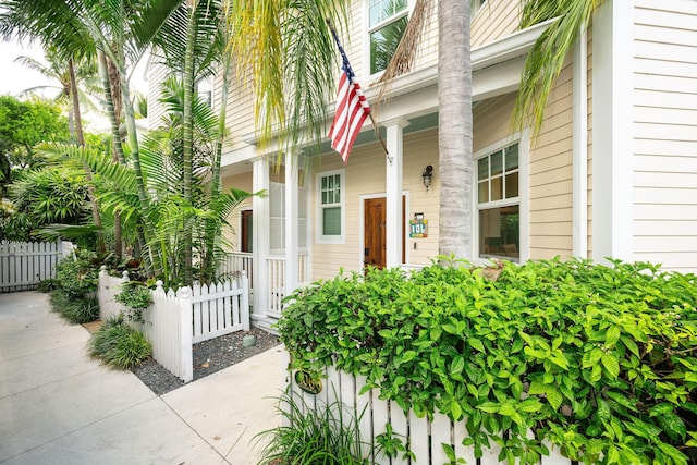 106 Admirals Ln, Key West, FL 33040 - doorway to property with covered porch and fence