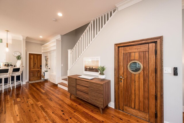 106 Admirals Ln, Key West, FL 33040 - entrance foyer with wood finished floors, ornamental molding, stairway, recessed lighting, and baseboards