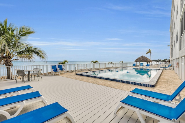 view of swimming pool featuring a deck with water view