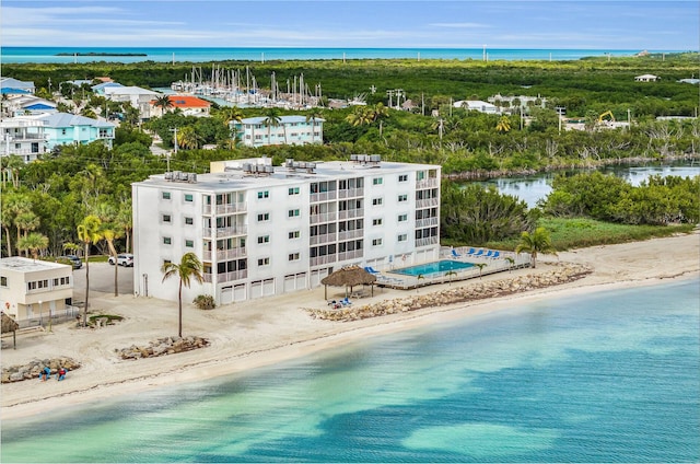 drone / aerial view featuring a water view and a beach view