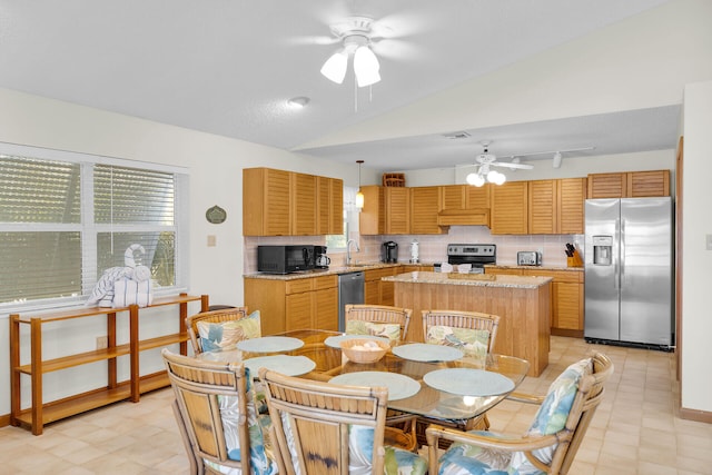 444 Calle De Luna, Marathon, FL 33050 - interior space with lofted ceiling, premium range hood, a kitchen island, appliances with stainless steel finishes, and ceiling fan