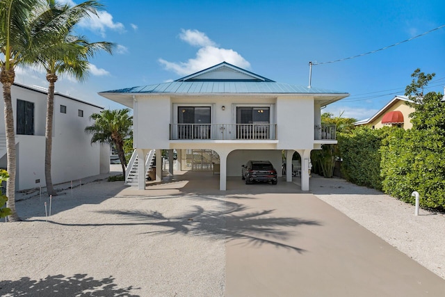 444 Calle De Luna, Marathon, FL 33050 - raised beach house featuring a carport, aphalt driveway, metal roof, stairs, and stucco siding