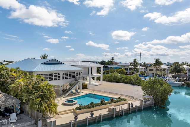 444 Calle De Luna, Marathon, FL 33050 - rear view of property featuring a fenced backyard, metal roof, stairway, a pool with connected hot tub, and a patio