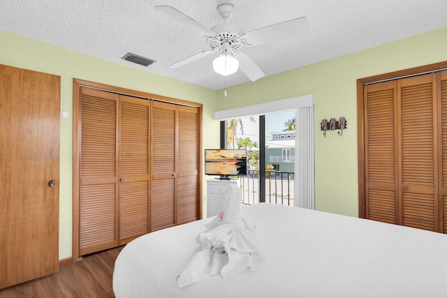 444 Calle De Luna, Marathon, FL 33050 - bedroom featuring a textured ceiling, ceiling fan, visible vents, access to exterior, and dark wood-style floors