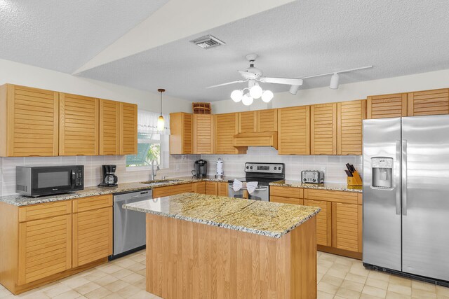 444 Calle De Luna, Marathon, FL 33050 - kitchen with backsplash, visible vents, a sink, a textured ceiling, and appliances with stainless steel finishes