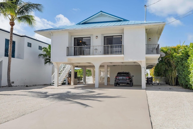 444 Calle De Luna, Marathon, FL 33050 - coastal home featuring a standing seam roof, a carport, metal roof, concrete driveway, and stairs