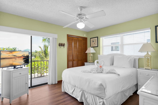 444 Calle De Luna, Marathon, FL 33050 - bedroom with dark wood-type flooring, a closet, access to exterior, and a textured ceiling