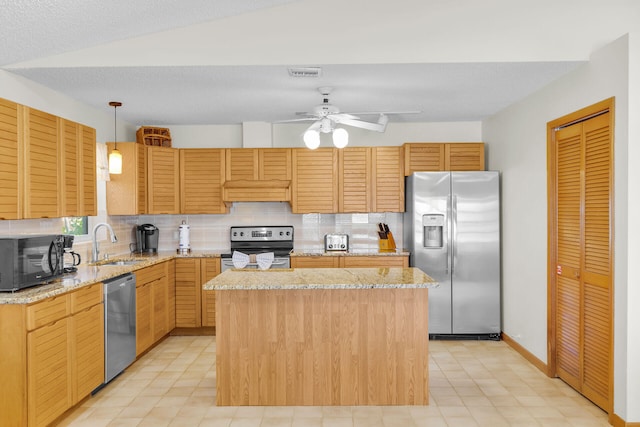 444 Calle De Luna, Marathon, FL 33050 - kitchen featuring a center island, tasteful backsplash, a sink, ceiling fan, and stainless steel appliances