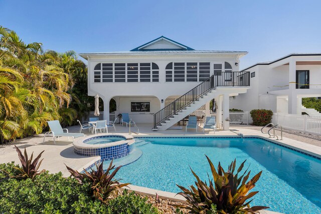 444 Calle De Luna, Marathon, FL 33050 - rear view of property with stairs, fence, stucco siding, a patio area, and a pool with connected hot tub