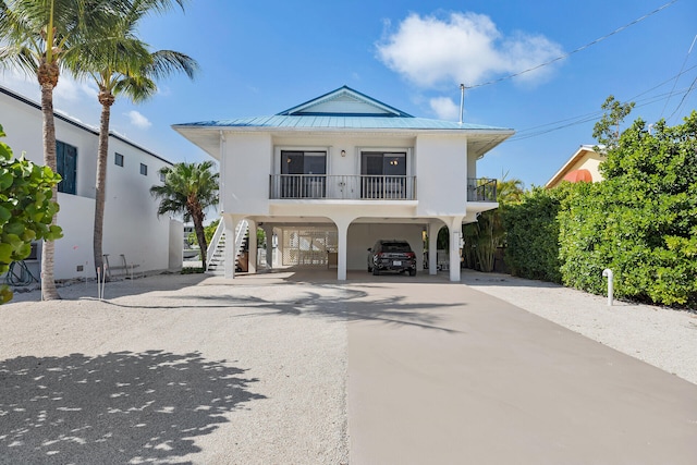 444 Calle De Luna, Marathon, FL 33050 - coastal home with a standing seam roof, a carport, driveway, metal roof, and stairs