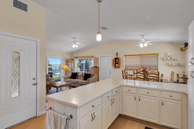 31135 Hollerich Dr, Big Pine, FL 33043 - kitchen featuring ceiling fan, light wood-style floors, lofted ceiling, light countertops, and hanging light fixtures
