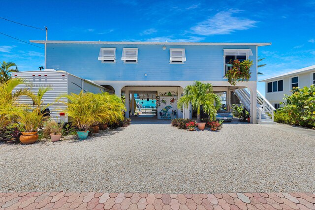 31135 Hollerich Dr, Big Pine, FL 33043 - beach home with a carport, stairway, and gravel driveway