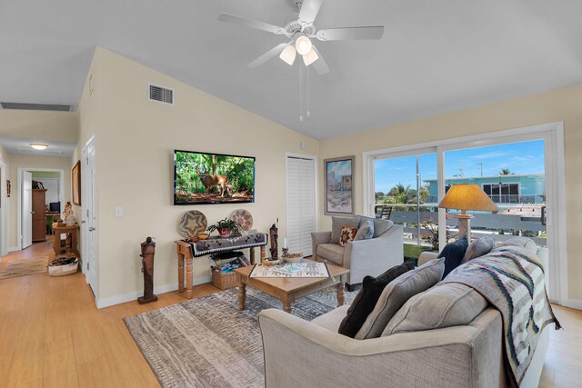 31135 Hollerich Dr, Big Pine, FL 33043 - living room with light wood-style flooring, baseboards, ceiling fan, and high vaulted ceiling
