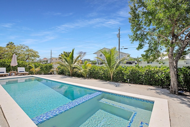 view of pool with an in ground hot tub