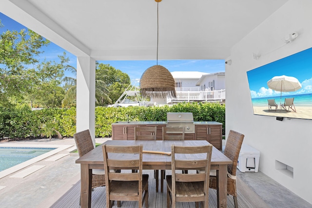 view of patio / terrace with exterior kitchen, area for grilling, and sink