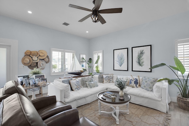 living room with ceiling fan and light hardwood / wood-style flooring