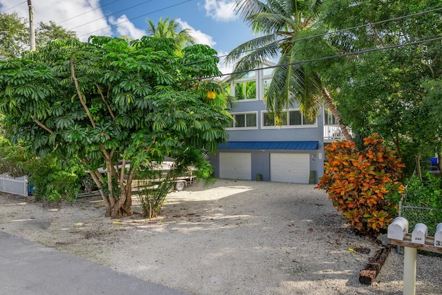 obstructed view of property with a garage