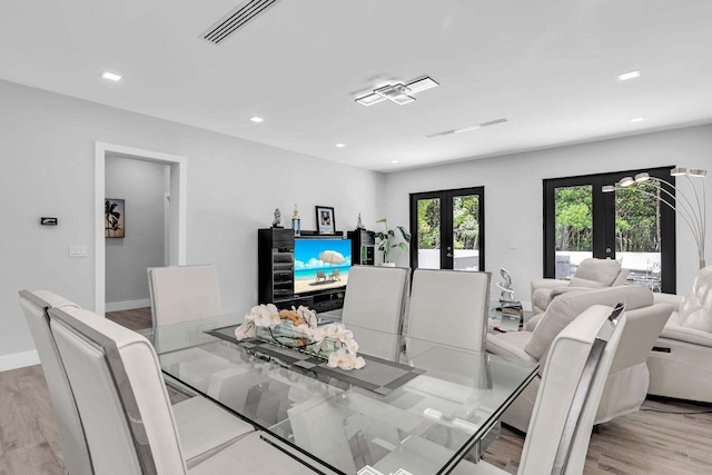 dining area with light wood finished floors, visible vents, baseboards, french doors, and recessed lighting