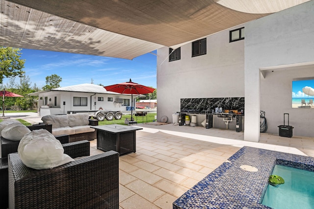 view of patio featuring an outdoor hangout area and exterior kitchen