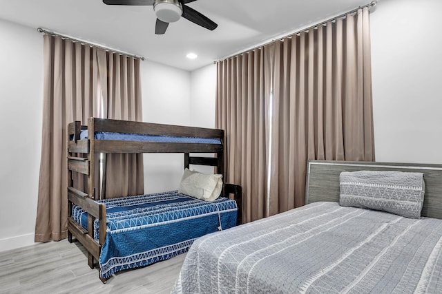 bedroom featuring a ceiling fan, recessed lighting, baseboards, and wood finished floors