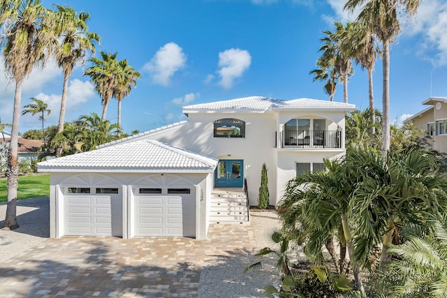 mediterranean / spanish house with a balcony and a garage