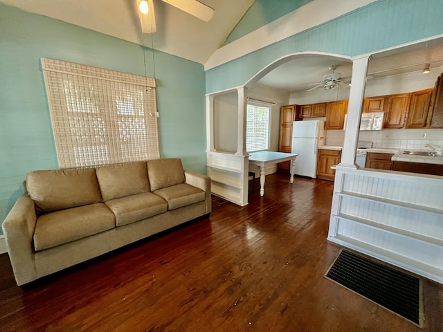 1122 Margaret St, Key West, FL 33040 - living area with arched walkways, ceiling fan, decorative columns, dark wood-style floors, and vaulted ceiling