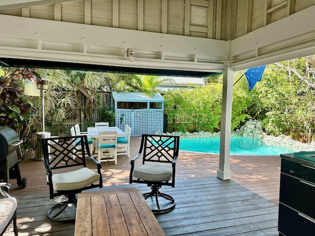 1122 Margaret St, Key West, FL 33040 - wooden deck featuring outdoor dining space, an outdoor pool, a shed, an outbuilding, and a gazebo